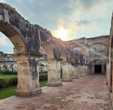 a brick building with arches and arches in the background