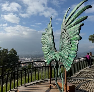 a statue of a bird with wings