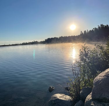 a lake with rocks and water in the background