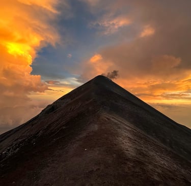 a mountain top with a mountain in the background