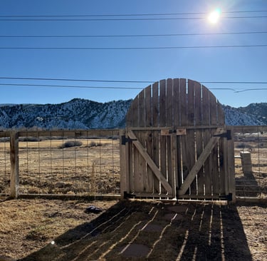 a barn door with a wooden gate and a fenced in area