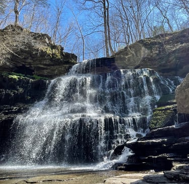 a waterfall in the middle of a rocky cliff