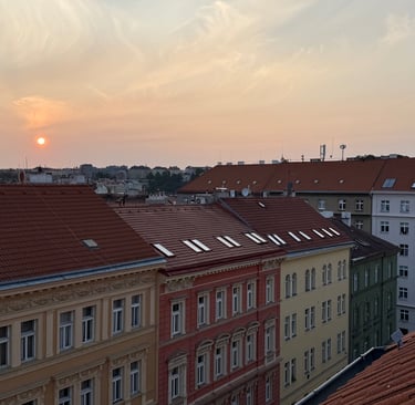 a sunset over a cityscapeople of buildings