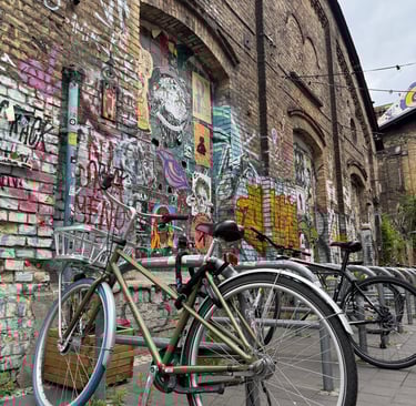 a bicycle parked next to a brick wall