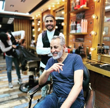 a man sitting in a chair in a barber shop