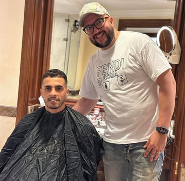a man is getting his hair cut by a barber