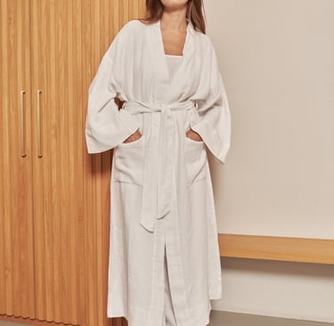a woman in a white robe and a white robe