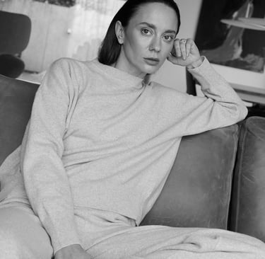 a woman sitting on a couch in a living room