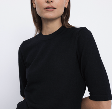 a woman in a black dress with a white background