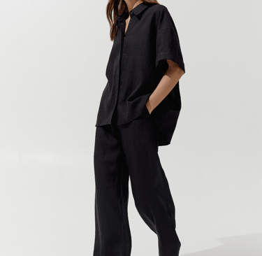 a woman in a black shirt and pants