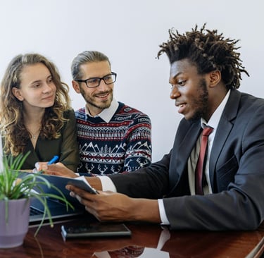 An agent explaining insurance benefits to a couple.