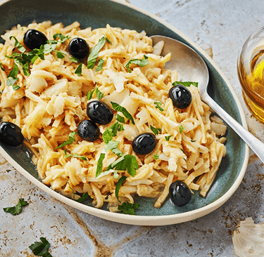 A plate of Bacalhau à Brás – traditional Portuguese codfish recipe with scrambled eggs, potatoes, an