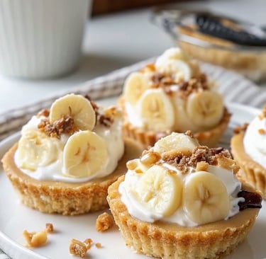 Close-up of No-Bake Mini Banana Cream Pies with whipped cream, banana slices, and chocolate shavings