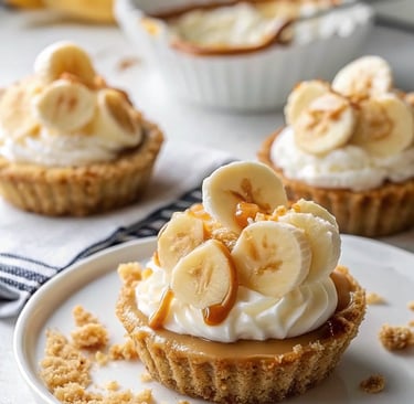 Mini Banana Cream Pies topped with whipped cream and banana slices