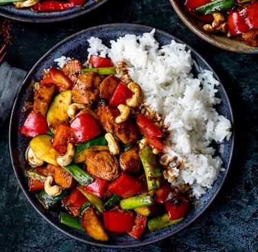 Authentic Kung Pao Chicken served with roasted peanuts, red chilies, and steamed rice.