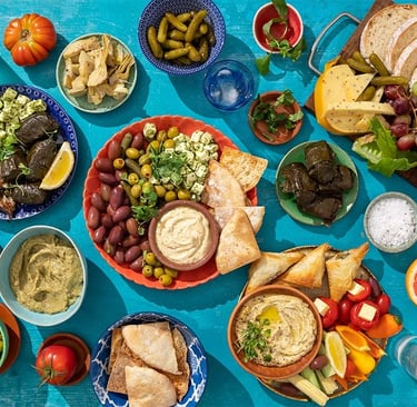 "Traditional Greek dishes including moussaka, souvlaki, and dolmades served with fresh ingredients l