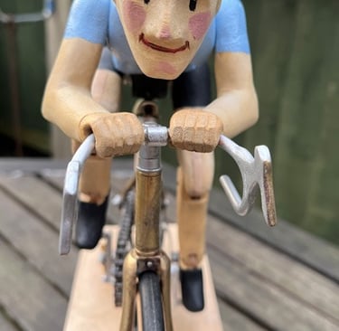 Front view of cyclist showing painted face and hands gripping handlebars