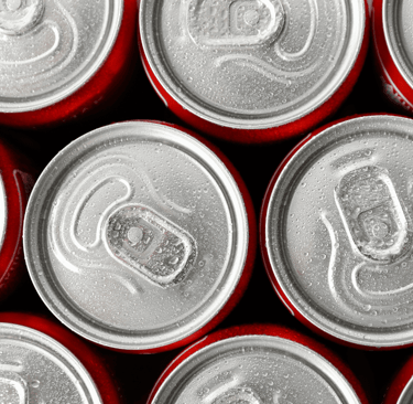 Top view of cold Coca-Cola cans with condensation — used to show recalled soda products affected by the FDA contamination ale