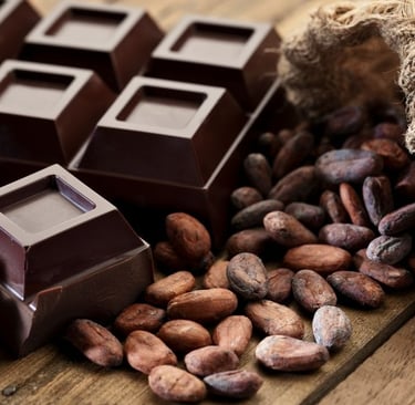 a bunch cocoa beans and chocolates on a table