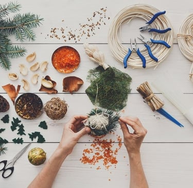 a person's hands are holding a christmas tree