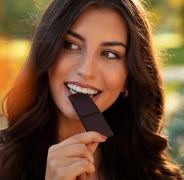 a beautiful woman eating vegan dark chocolate