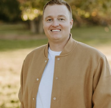 a man in a jacket and white shirt