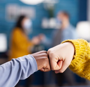 Duas mãos dando um toque com os punhos