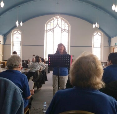 Janice leads choir at the Target Café