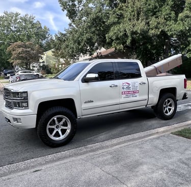 Company truck loaded with gutter materials and installation equipment.