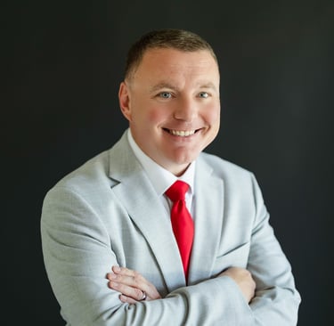 Shawn Kaeser in a suit and red tie