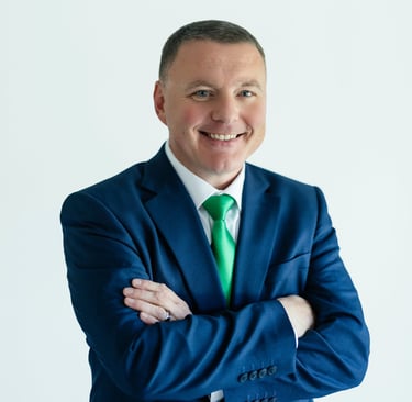 Shawn Kaeser in a suit and tie smiling