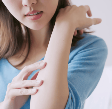 A woman with sensitive skin using tallow cream to soothe it 
