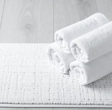 a pair of towels and a pair of towels on a white rug