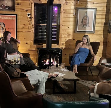 A private party group of people sitting in chairs in The Prairie Dog ;living room