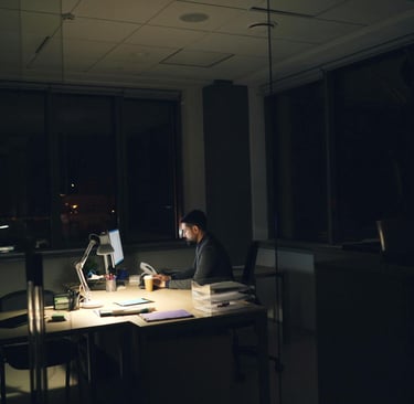an alone person in an empty office that hints towards how burnout and meaninglessness can be dangerous