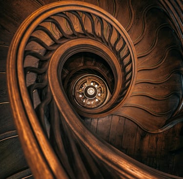 a spiral staircase case with a wooden spiral staircase