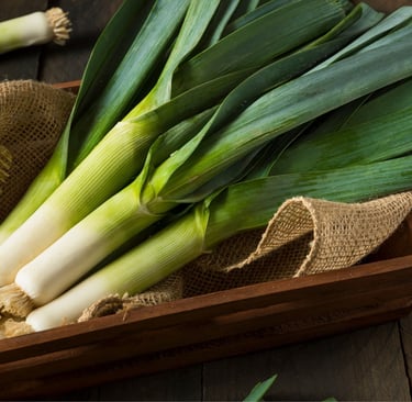 Leeks in a dish on a table in an old kitchen