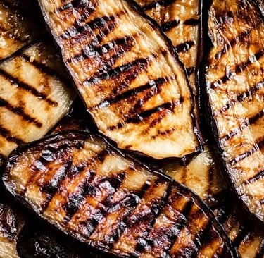 Close-up of juicy grilled eggplant slices with grill marks