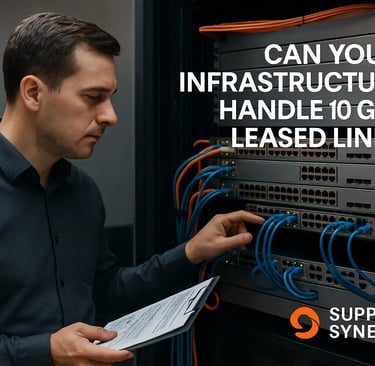 IT manager inspecting network rack with switches and fibre cabling while reviewing leased line upgrade plans