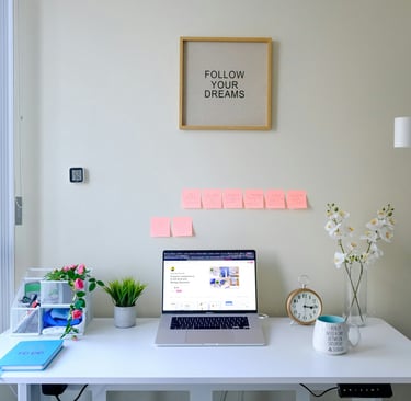 a laptop computer sitting on a desk with a note pad attached to it