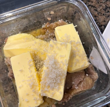 Container with roasted bone marrow, softened butter, and unrefined salt ready to be mixed