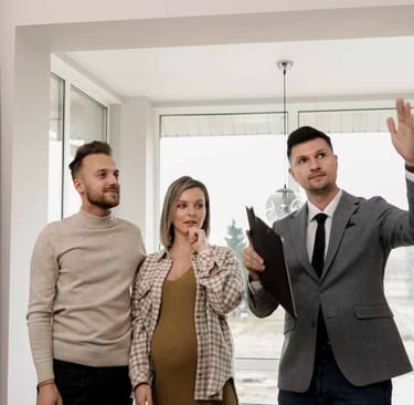 a man and woman standing in front of a window