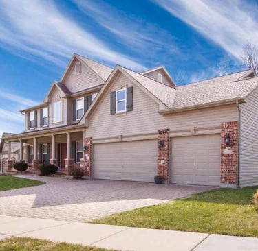 a house with a driveway and a garage door