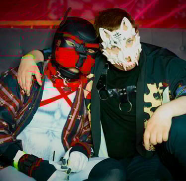 2 men in pup masks posing together.