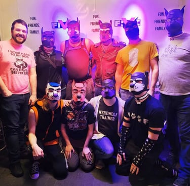 A group of men posing in pup masks.