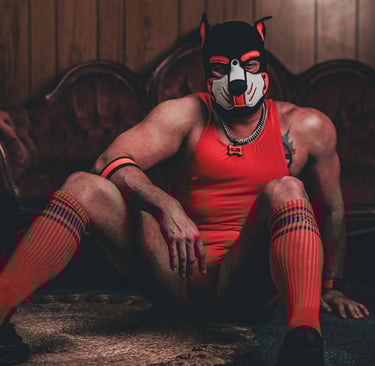 Man in pup mask, posing on the floor.