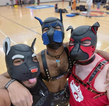 Three men in a gymnasium posing pup masks.