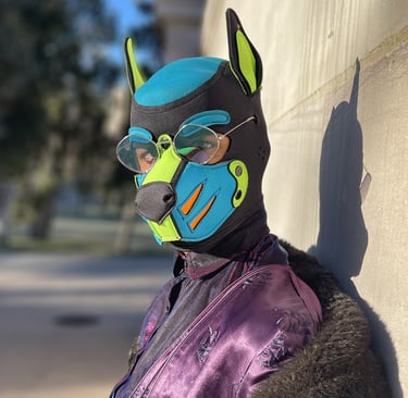 A man in a pup mask posing against a wall.
