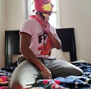 Man posing in his room wearing a pup hood.