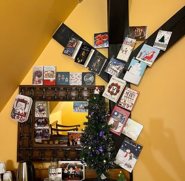 Christmas cards and tree up in hotel room in Ryn caste